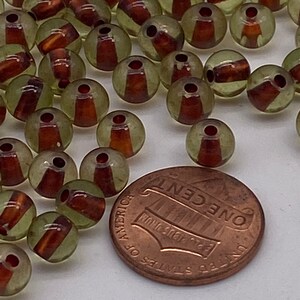 Small glass bead with center stripe. ( 40 pieces per price)
