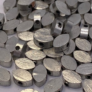Silver almond shaped beads. Brass. 7mm. (20 pieces per price)