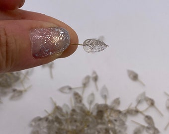 Pressed glass leaves with fused brass eye pin. 12mm (Clear ) (30 pieces per price)