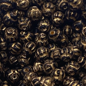 Opaque gold and black glass beads from India. ( 30 pieces per price)
