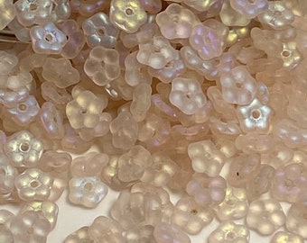 Petite pastel pink glass flowers with a beautiful opalescent cast. 5mm Czech Republic,( 50 pieces per price)