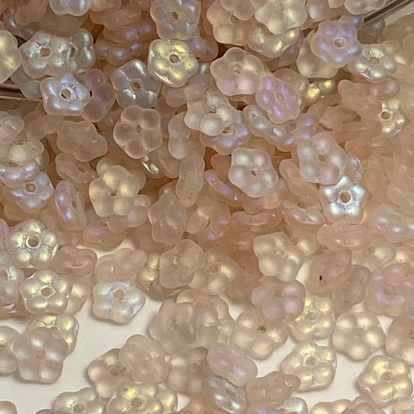 Petite pastel pink glass flowers with a beautiful opalescent cast. 5mm Czech Republic,( 50 pieces per price)