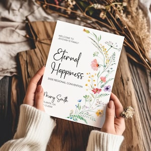 May include: A white invitation with the words "Eternal Happiness" and "2026 Regional Convention" in black script. The invitation is decorated with watercolor floral elements in pink, yellow, and purple. The text "Welcome to Jehovah's Family" is at the top.
