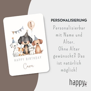 May include: A birthday card featuring a watercolor illustration of five dogs wearing party hats. A balloon with the number 1 floats above them. The words "Happy Birthday Cara" are written below the dogs.