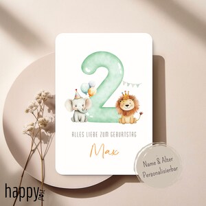 May include: A birthday card featuring a large, mint green number 2 with an elephant wearing a party hat and a lion wearing a crown. The card includes the text "Alles Liebe zum Geburtstag" and the name "Max".