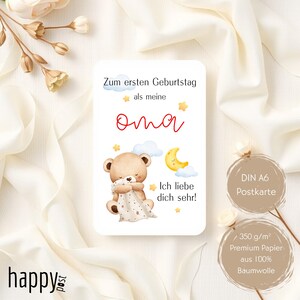 May include: A rectangular greeting card with a teddy bear illustration, a crescent moon, and stars. The text reads "Zum ersten Geburtstag als meine oma Ich liebe dich sehr!" and "DIN A6 Postkarte". The card is on a white background.