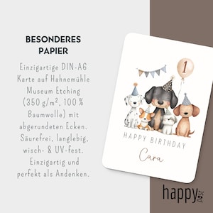 May include: A birthday card featuring a watercolor illustration of five dogs wearing party hats. The card reads "Happy Birthday Cara" with a number one balloon. The card is printed on high-quality paper.