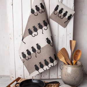 Handmade kitchen tea towel with a black cats design.
