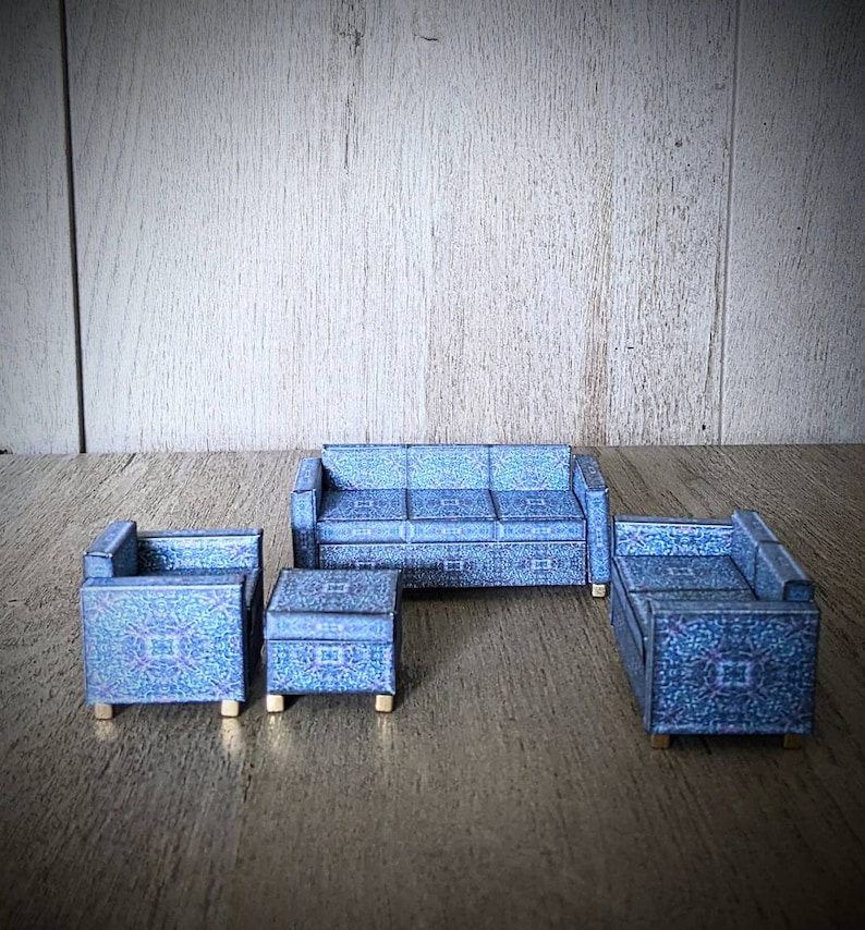 May include: A blue patterned living room furniture set with a sofa, two armchairs, and a coffee table.