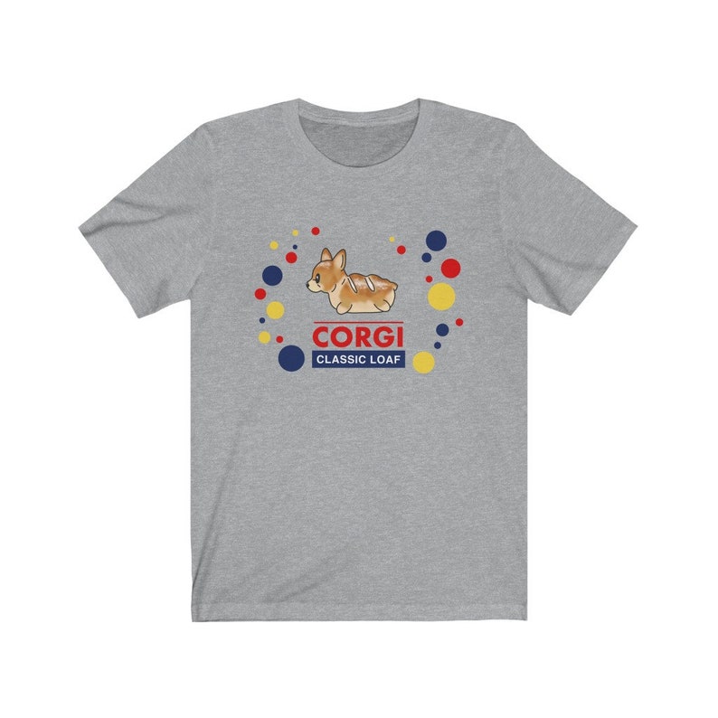May include: A gray t-shirt with a cartoon corgi dog shaped like a loaf of bread. The text "Corgi Classic Loaf" is printed below the dog.