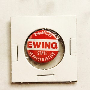 May include: Red, white, and blue campaign button with the text "Republican" at the top, "Ewing" in large red letters, "State Representative" below, and a clear plastic covering.