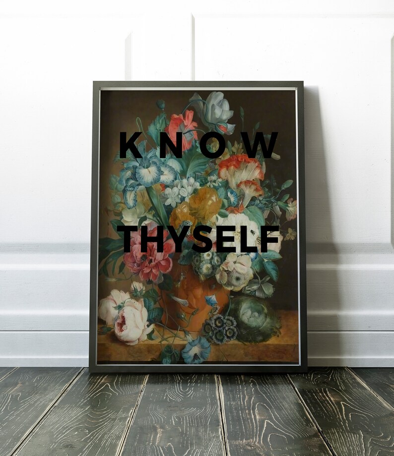 May include: A framed rectangular wall art print featuring a classical floral still life painting in an orange vase. The bouquet includes white, pink, yellow, and blue flowers. The black text KNOW THYSELF is centered over the floral arrangement.