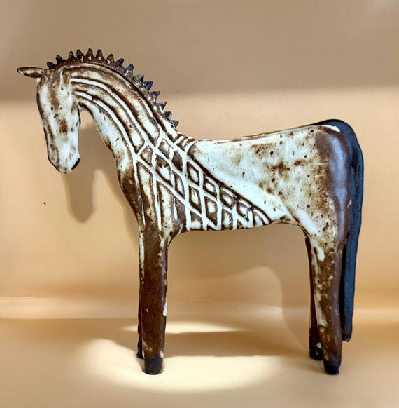 Carved white on black ceramic horse sculpture