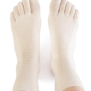 May include: A pair of off-white toe socks with five individual toe compartments. The socks are made of a soft, breathable fabric and are designed to provide comfort and support.