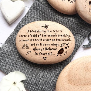 May include: Three wooden heart-shaped ornaments with inspirational quotes. The first ornament says "Always see the good in people, they're always there." The second ornament says "A bird sitting in a tree is never afraid of the branch breaking, because its trust is not on the branch, but on its own wings. Always Believe in Yourself..." The third ornament is blank.