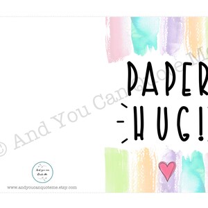 May include: A printable card with a watercolor background in shades of pink, blue, green, and yellow. The card says "PAPER HUG!" in black text with a small pink heart in the center.