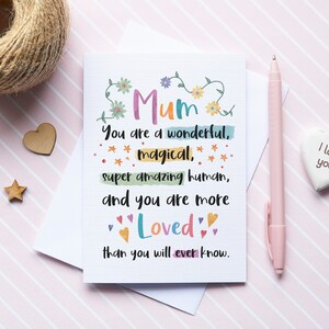 May include: A colourful card with the text "Mum You are a wonderful, magical, super amazing human, and you are more Loved than you will ever know."