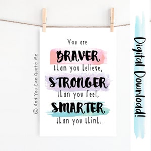 May include: A printable digital download with a motivational quote: "You are BRAVER than you believe, STRONGER than you feel, SMARTER than you think." The quote is written in black text on a white background with colorful watercolor stripes behind each word.