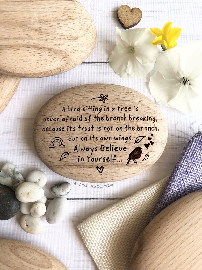 May include: Wooden oval sign with a quote about trusting in yourself. The quote reads: "A bird sitting in a tree is never afraid of the branch breaking, because its trust is not on the branch, but on its own wings. Always Believe in Yourself..."