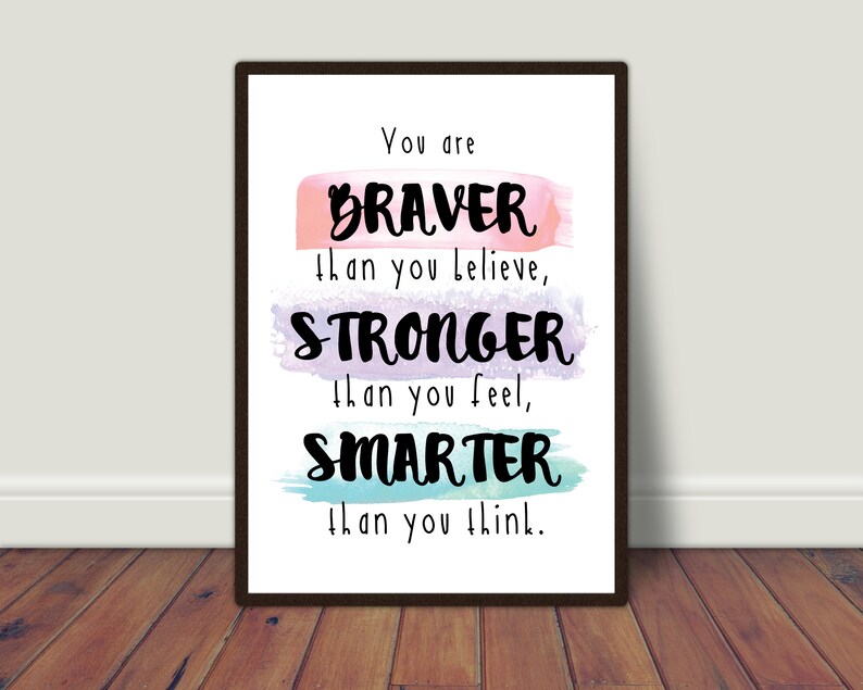 May include: A motivational quote printed on a white background with a black frame. The quote reads "You are BRAVER than you believe, STRONGER than you feel, SMARTER than you think."