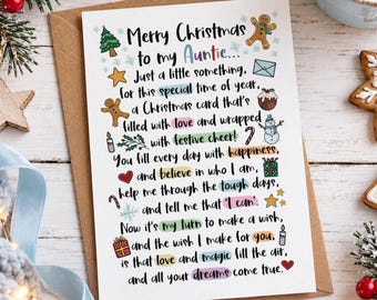 May include: A white rectangular Christmas greeting card addressed to an Auntie with black text and colorful illustrations including a gingerbread man, Christmas tree, snowman, gifts, and stars. The card features a heartfelt holiday poem.