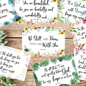 May include: A set of six inspirational cards with watercolor floral and tropical leaf designs. Each card features a different Bible verse and the corresponding Psalm number. The verses include "You are beautiful, for you are fearfully and wonderfully made. Psalm 139:14", "Be Still AND Know THAT I AM With You. Psalm 46:10", "It is God who with Strength keeps my way. Psalm", "In the out, you me", "He shall give his angels charge over you to keep you in all your ways. Psalm 91:11", and "Let all that I am wait quietly before God. For my hope is in him. Psalm 62:5".