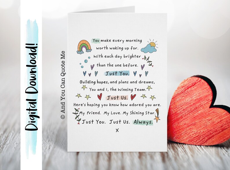May include: A white card with a handwritten message about love and friendship. The card features a rainbow, a sun, clouds, stars, and hearts. The text reads: "You make every morning worth waking up for. With each day brighter than the one before. Just You. Building hopes, and plans and dreams, You and I, the winning Team. Just Us. Here's hoping you know how adored you are. My Friend. My Love. My Shining Star. Just You. Just Us. Always. X"
