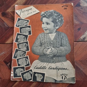 May include: A vintage knitting book cover featuring a young girl wearing a knitted cardigan. The cover is orange and features the title "Paragon Knitting Book" and "Cuddle Cardigans". The price is listed as "1 1/3".