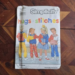 May include: Simplicity sewing pattern for children's clothing. The packet displays the words "hugs + stitches" in a rainbow of colours. The illustration shows four children in various outfits, including a jacket, trousers, and a dress.