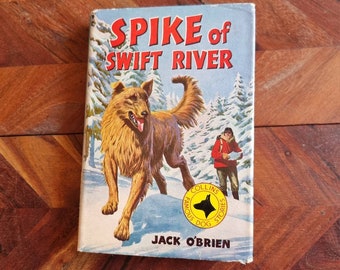 May include: A vintage book cover with a colorful illustration of a dog running through a snowy forest. The book title is "SPIKE of SWIFT RIVER" and the author is "JACK O'BRIEN".