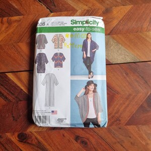 May include: Simplicity sewing pattern for a women's cardigan. The pattern includes four different styles, with a long, flowing design and a shorter, more fitted design. The pattern is for sizes XXS-XXL.