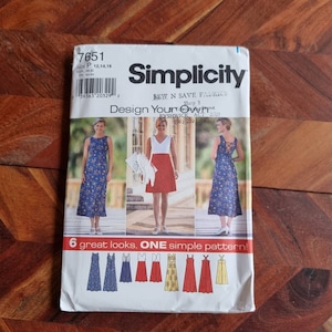 May include: Simplicity sewing pattern number 7651, "Design Your Own", featuring six different styles of dresses. The pattern includes instructions for a sleeveless dress with a V-neck, a sleeveless dress with a scoop neck, and a sleeveless dress with a criss-cross back.