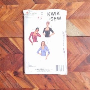 May include: A sewing pattern for a women's top with three different sleeve options. The pattern is from Kwik-Sew and is number 2828. The pattern is $3.