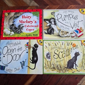 May include: Four children's books by Lynley Dodd are displayed. The titles include "Hairy Maclary's Caterwaul Caper", "Hairy Maclary's Rumpus at the Vet", "Slinky Malinki, Open the Door", and "Hairy Maclary Scattercat". The covers feature colorful illustrations of animals.