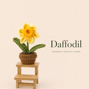 May include: A yellow crochet daffodil flower with green leaves planted in a brown crochet pot, resting on a small wooden step stool. The text Daffodil HANDMADE CROCHET FLOWER is printed to the right of the flower against a light background.