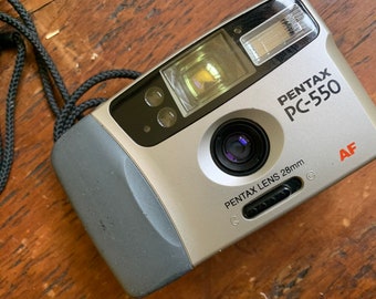 Pentax PC-550 point and shoot camera. Takes AA batteries. Working condition.