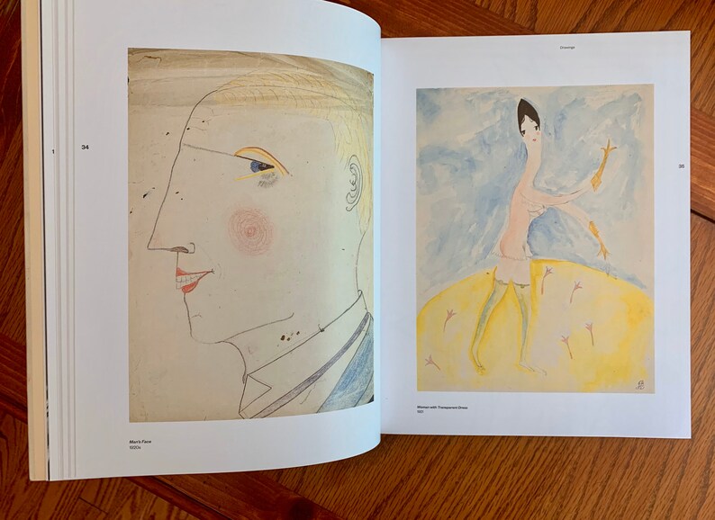 May include: Two black and white drawings on a white background. The drawing on the left is a profile of a person's face. The drawing on the right is a person with long legs and arms, wearing a hat and stockings, standing on a yellow circle.
