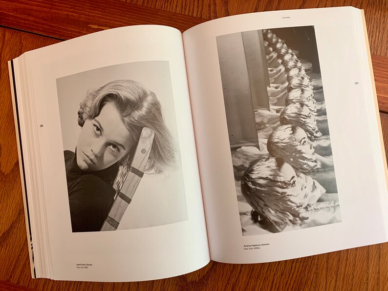 May include: A black and white photograph of a woman with her head resting on a wooden chair. The woman is looking directly at the camera with a serious expression. The photograph is from the book "Faces" by John French, New York 1969.