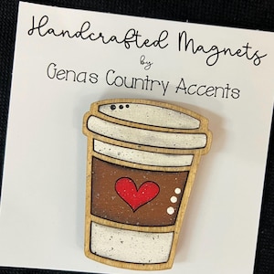 May include: Handcrafted wooden coffee cup magnet with a red heart and white dots. The magnet is on a white card with the text "Handcrafted Magnets by Genas Country Accents".