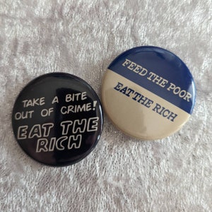 Set of 2 "Eat The Rich" Pinback Buttons - 1.5"