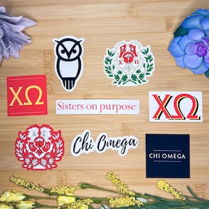 May include: A set of eight stickers featuring the Greek letters XO, the words "Chi Omega" and "Sisters on purpose", a red crest with a heart and flowers, a black and white owl, and a crest with a heart and flowers.