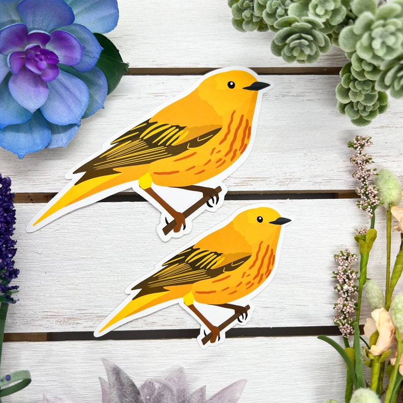 May include: Two yellow warbler bird stickers with black markings. The birds are facing different directions and have their wings spread out.