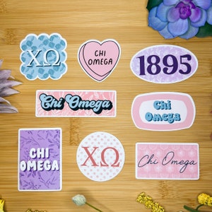 May include: A set of nine stickers featuring various designs related to the sorority Chi Omega. The stickers include the letters "XO", the words "Chi Omega", and the year "1895". The stickers are in various colors, including pink, purple, blue, and white.