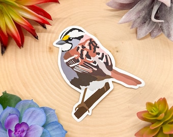 Puede incluir: Una pegatina de un gorrión de garganta blanca con un esquema de color marrón, rosa y gris. El pájaro está posado en una rama con las alas extendidas.
