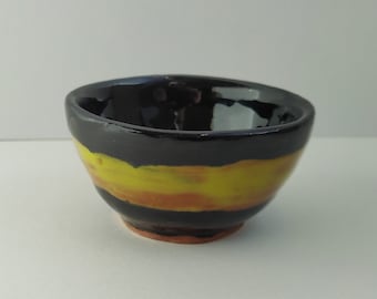 Handmade black and yellow ceramic bowl