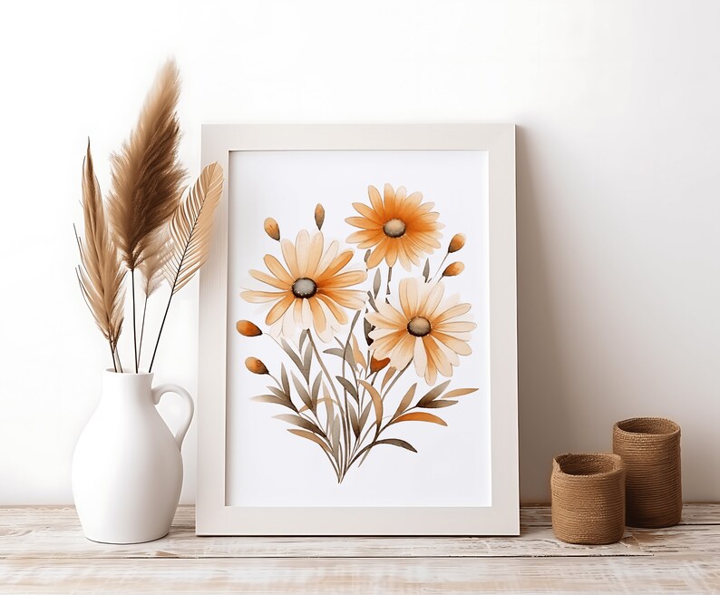 May include: A framed print of a watercolour painting featuring a bouquet of three orange and yellow daisies with brown stems and leaves on a white background.