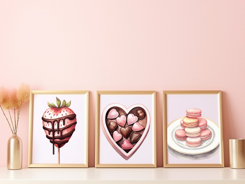 May include: Three framed illustrations of Valentine's Day treats. The first shows a chocolate-covered strawberry on a stick. The second shows a heart-shaped box of chocolates. The third shows a stack of pink and white macarons on a white plate.