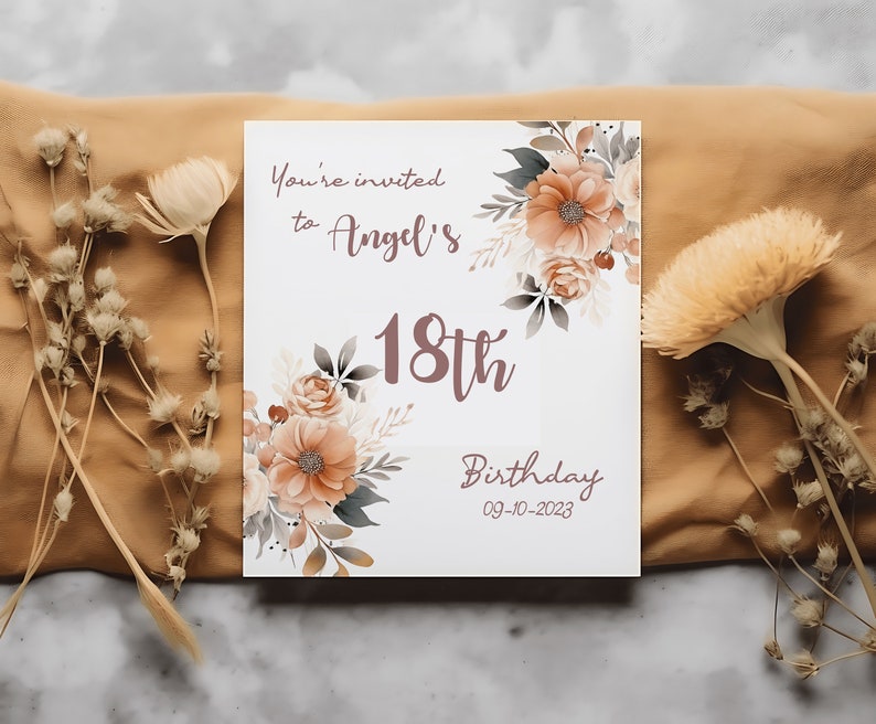 May include: A white invitation card with a floral design in shades of brown and beige. The text reads "You're invited to Angel's 18th Birthday 09-10-2023".
