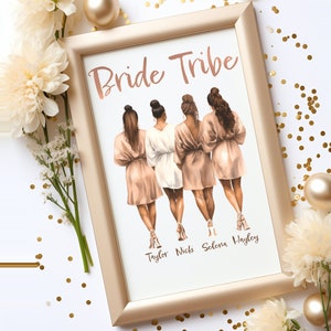 May include: A framed print with the text "Bride Tribe" at the top.  Four women in robes are standing in a row, facing away from the viewer.  The names "Taylor, Nicki, Selena, Hayley" are written below the women.