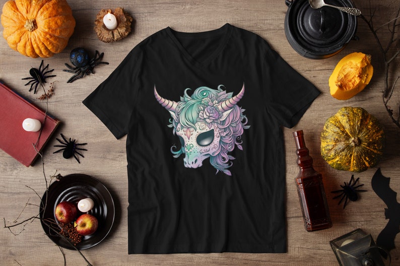May include: Black V-neck t-shirt featuring a colourful sugar skull unicorn design. The unicorn has a pink, blue and green mane and flowers on its head.
